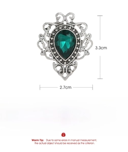 Detailed view of vintage silver alloy brooch with green teardrop gem and size dimensions