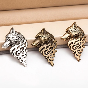 Vintage wolf head brooches with Celtic knots in silver, bronze, and gold metal finishes