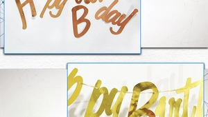 Detail of gold foil Happy Birthday banner showing metallic texture and letter cutouts