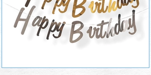 Close-up of gold and silver Happy Birthday banners with reflective metallic texture