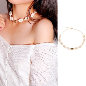 Bohemian style choker featuring natural white shells and a single gold accent shell piece