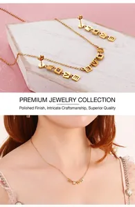 Detailed view of gold stainless steel LOVE pendant necklace and earring set on model