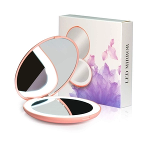 Pink folding LED makeup mirror with round design and floral gift box on white background
