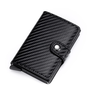 Detail of carbon fiber texture and automatic pop-up button on minimalist wallet