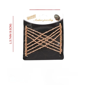 Detail view of Magic Comb hair clip with golden beads and technical specifications