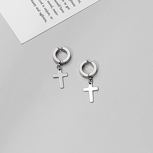 Close-up of a pair of silver stainless steel cross pendant ear clips on grey background