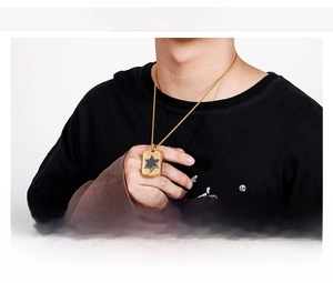 Detailed view of men's stainless steel shield necklace with black hexagram pendant