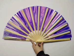 Detail of purple iridescent laser film surface and natural bamboo ribs of the folding fan