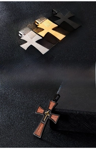 Detailed close-up of retro stainless steel cross pendants on a textured black background