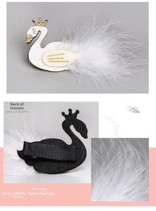 Detail shot of swan hair clip showing glitter texture, white feathers and back metal clip