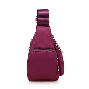 Purple nylon crossbody bag with quilted stitching and multiple pocket side view