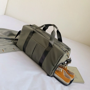 Detail showing independent shoe compartment in army green nylon sports bag with shoes inside