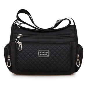 Black quilted nylon crossbody bag with multi-zipper pockets and adjustable strap