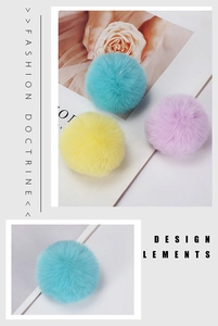 Detailed view of soft 8cm faux rabbit fur pom poms in blue, yellow, and purple colors