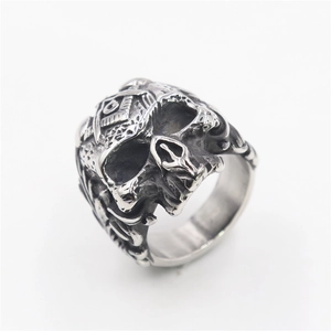 Detailed view of stainless steel skull ring with gothic masonic engraving on white background