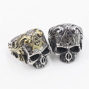 Detail of gothic stainless steel masonic skull rings in vintage silver and gold finish