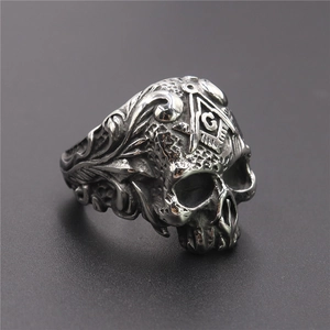 Macro shot of stainless steel Freemason skull ring with ornate G logo and scrollwork