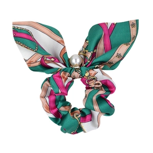Detail view of pearl pendant and floral chain pattern on the scrunchie bow hair tie