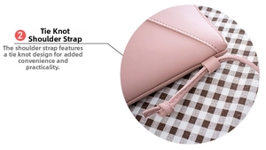 Close-up of pink faux leather bag showing knot strap design and precision stitching