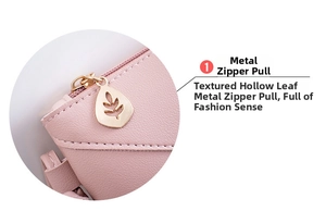 Close-up of golden leaf-shaped hollow zipper pull on pink leather envelope bag