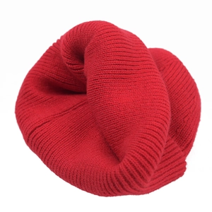 Bright red knitted beanie for kids and adults with soft ribbed texture on white background