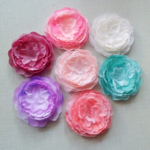 Detailed close-up of multicolored fabric rose and peony flowers for bridal headpieces