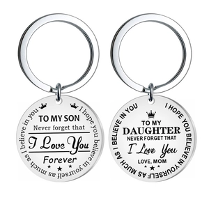 Detail of round stainless steel keychains with sentimental engraved messages for son and daughter