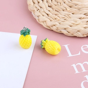 Detailed view of handmade resin pineapple charms with metal rings for DIY jewelry making
