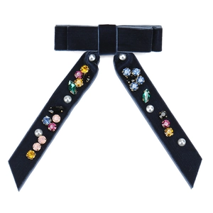 Dark blue velvet bow hair clip with colorful crystals and pearls on white background