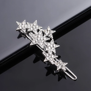 Macro shot of silver alloy hair clip with sparkling rhinestones in star shapes
