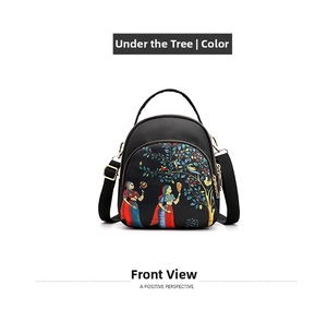 Front view of small black nylon backpack with folk art print and adjustable straps