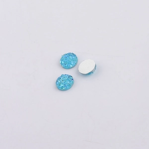 Macro shot of 8mm blue resin druzy cabochons showing textured fronts and flat silver back