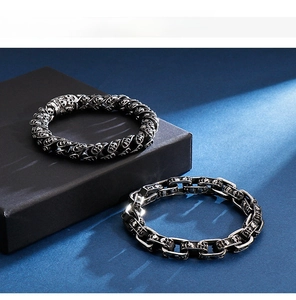 Close-up of vintage punk skull link bracelets in oxidized stainless steel for men