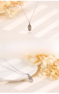 Detailed view of silver Virgin Mary oval pendant necklace with vintage embossed texture