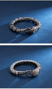 Close-up of a silver snake-scale bracelet and a leopard head link bracelet with gems
