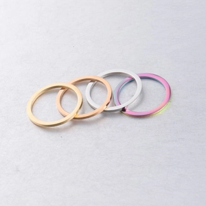 Set of four 25mm geometric stainless steel round rings in gold, silver, and rainbow colors