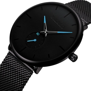 Detail of minimalist black watch dial with blue hands and mesh metal strap on white background