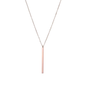 Detailed view of polished rose gold geometric bar pendant on a minimalist chain necklace