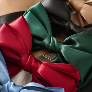 Elegant multi-layered satin bow hair clips in various colors with silky texture