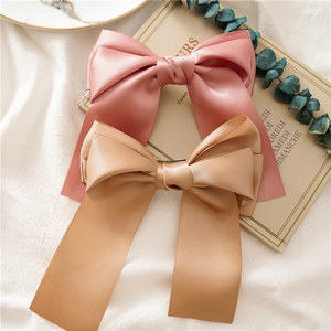 Elegant satin bow hair clip set in pink and champagne with long ribbons for women