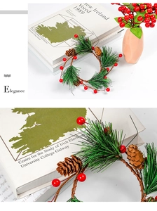 Detailed close-up of artificial pine needles, red berries, and natural pine cones on a wreath