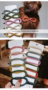 Close-up of matte Morandi colored hair clips with infinity and oval geometric shapes