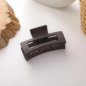 Macro shot of large square hollow hair claw clip with a premium matte coffee finish