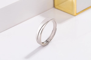 Close-up of polished silver adjustable couple ring with diamond-set cubic zirconia