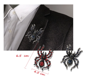 Macro view of crystal spider brooch showing 6.5 cm by 4.5 cm dimensions on suit