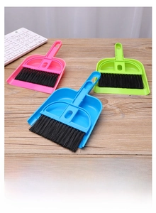 Close-up of mini desktop broom and dustpan set for keyboard and gap cleaning