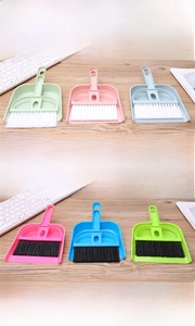 Close-up of mini desk broom and dustpan set nesting handle for keyboard and gap cleaning