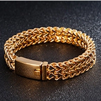 Macro shot of gold-plated woven chain bracelet featuring a sleek rectangular clasp detail