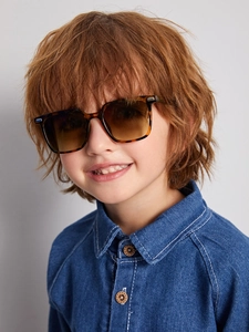 Close-up of tortoise shell sunglasses for kids with tea gradient lenses on a child model