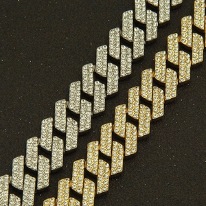 Close-up of 20mm iced out Cuban link chains in gold and silver with zircon diamonds